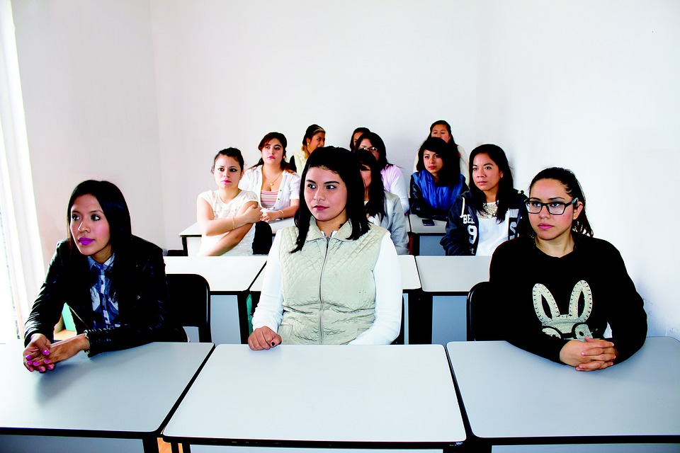 A small group of students in a college classroom.