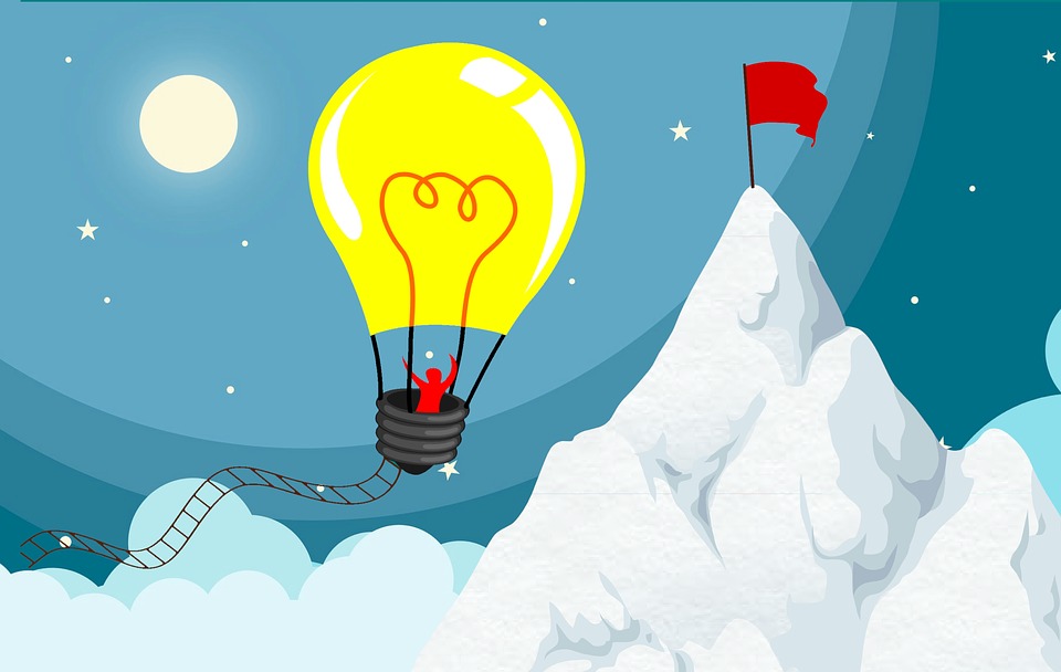 Person in a lightbulb-shaped hot air balloon drifting towards their goal, marked by a red flag.